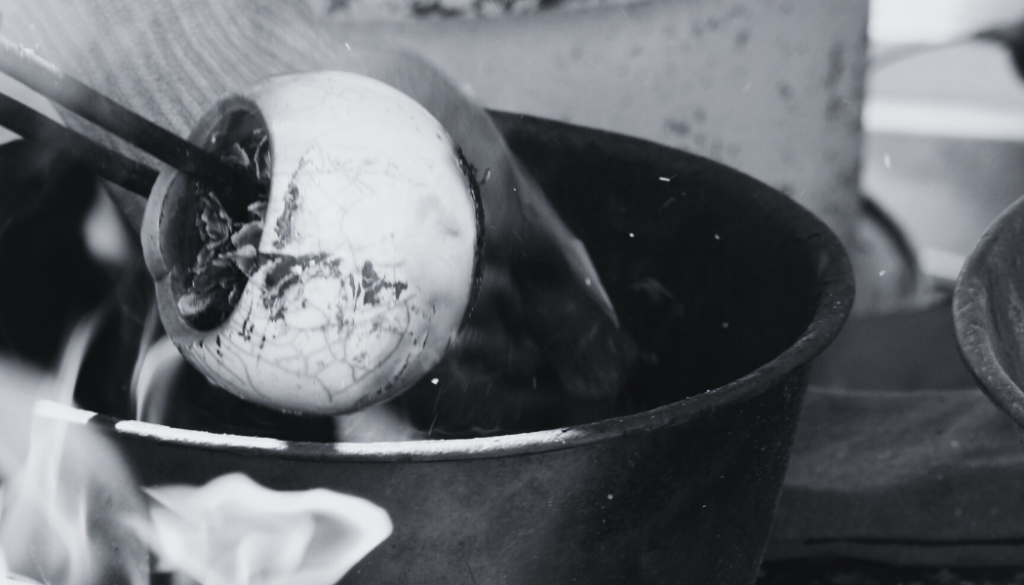 Application de la technique de Raku – Choc thermique et sciure pour créer des effets uniques sur la céramique, réalisé à l’Atelier de la Terre Ronde.