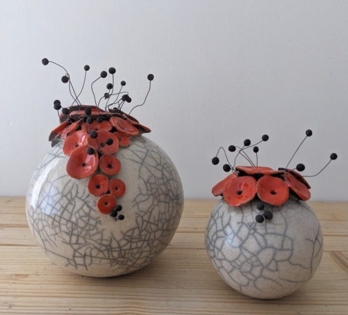 Fleur orange et blanche en céramique, décor floral en forme de boule, créé à l’Atelier de la Terre Ronde.